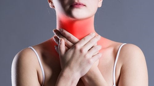 women clutching her sore throat