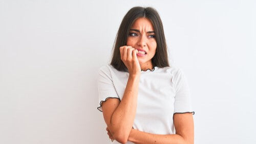 Woman nervously biting her fingers